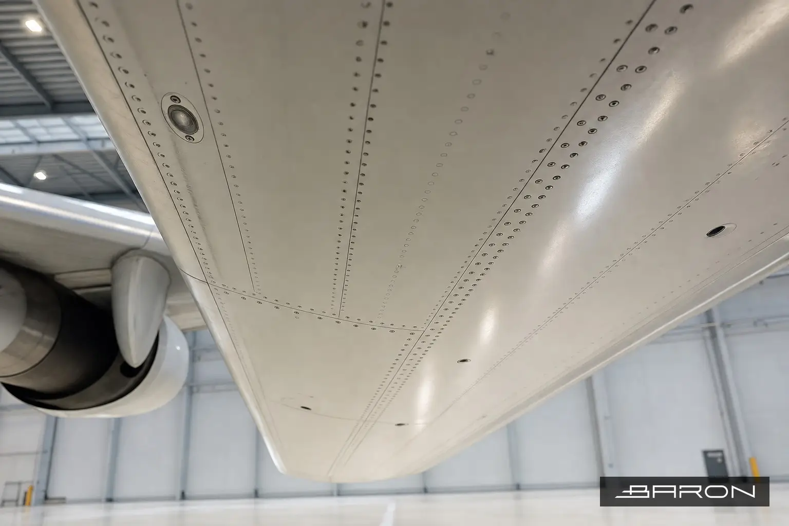 A220 wing bottom cover underside showing fastener rows and buttstrap splice joint inspected by phased array UT