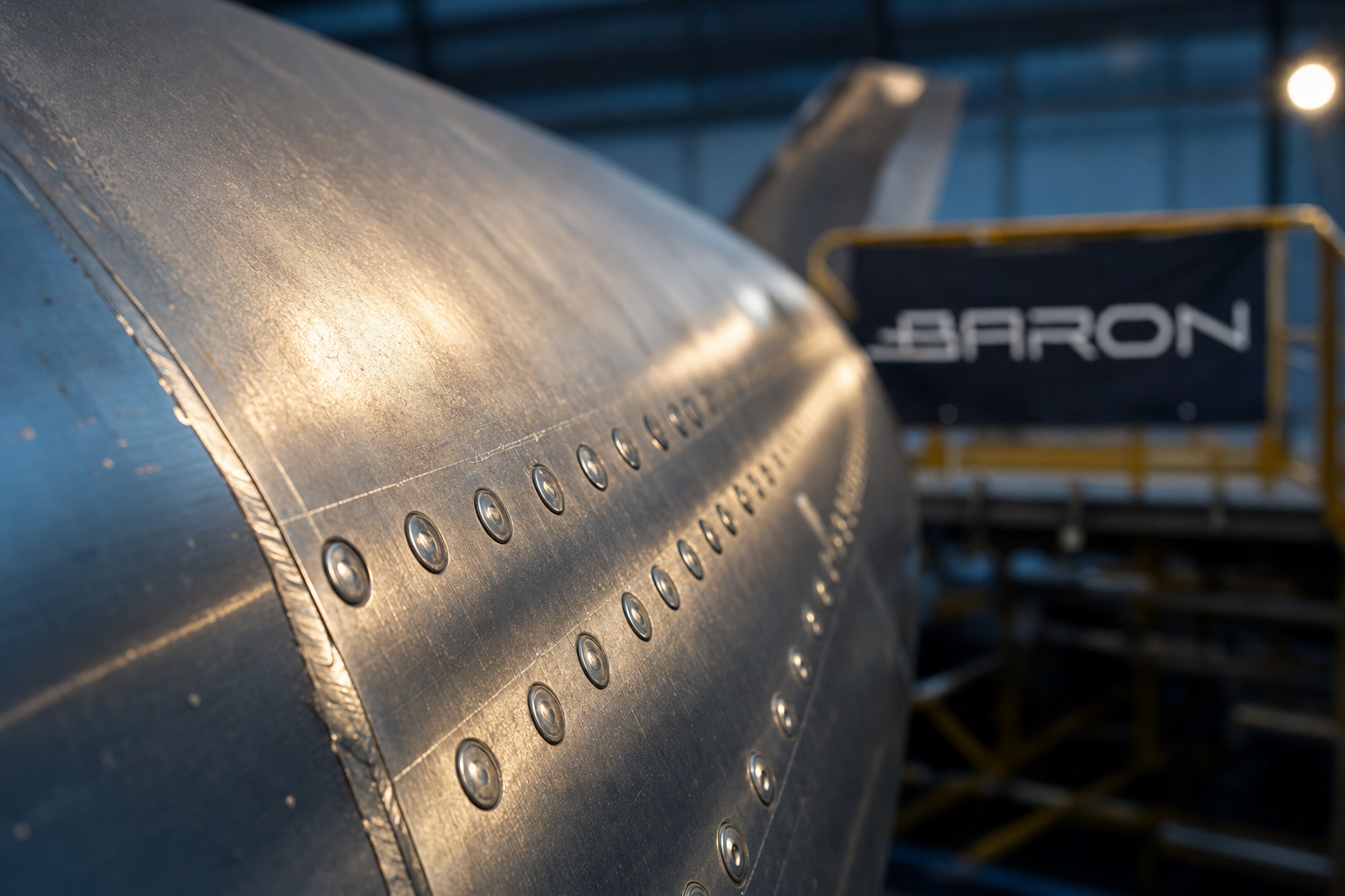 Raking-light macro of a Boeing 767 riveted fuselage skin lap joint, the scribe-line cracking inspection zone covered by FAA AD 2026-05-03