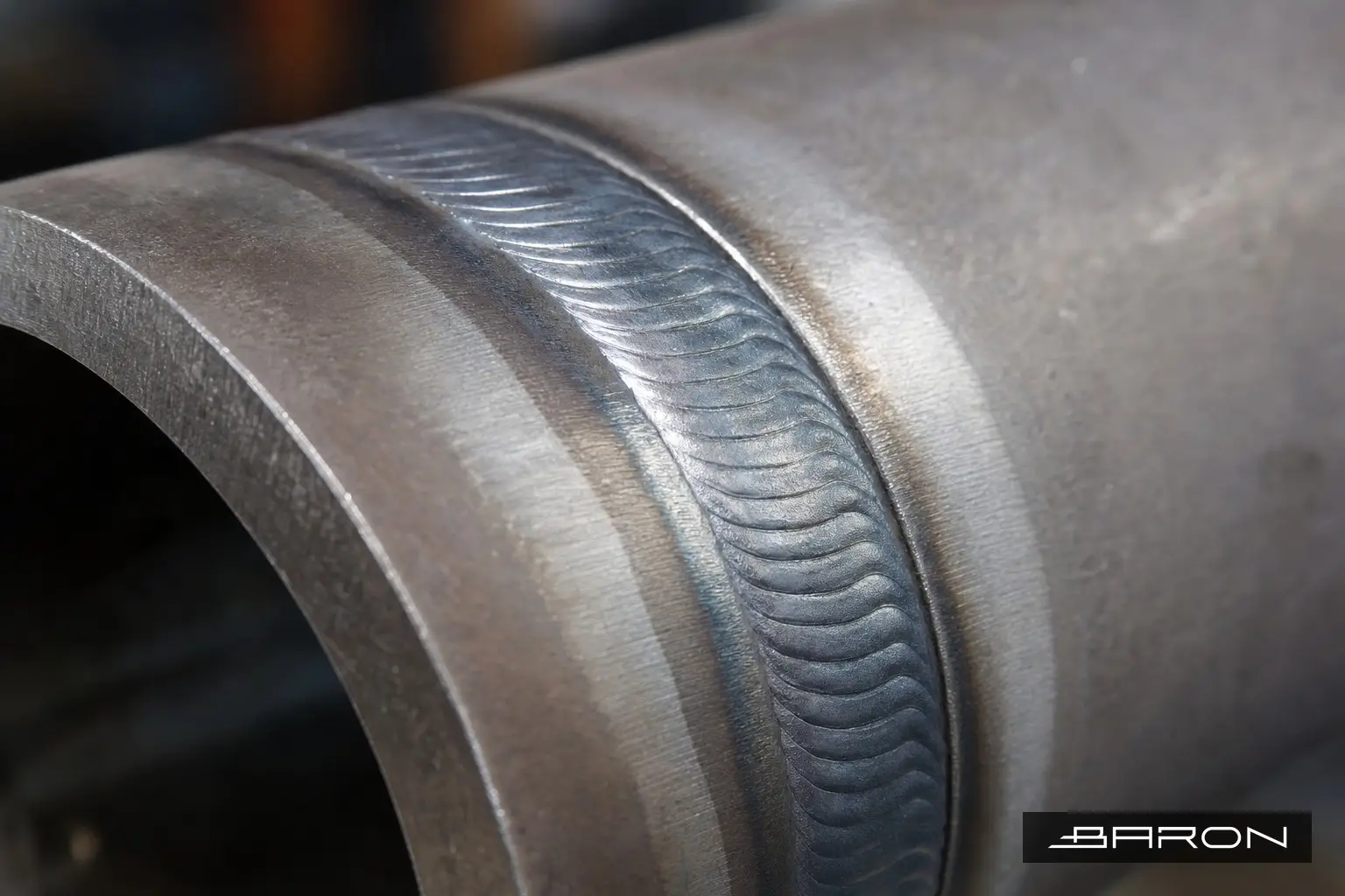 Clean weld bead seam on carbon steel pipe inspected with surface NDT methods