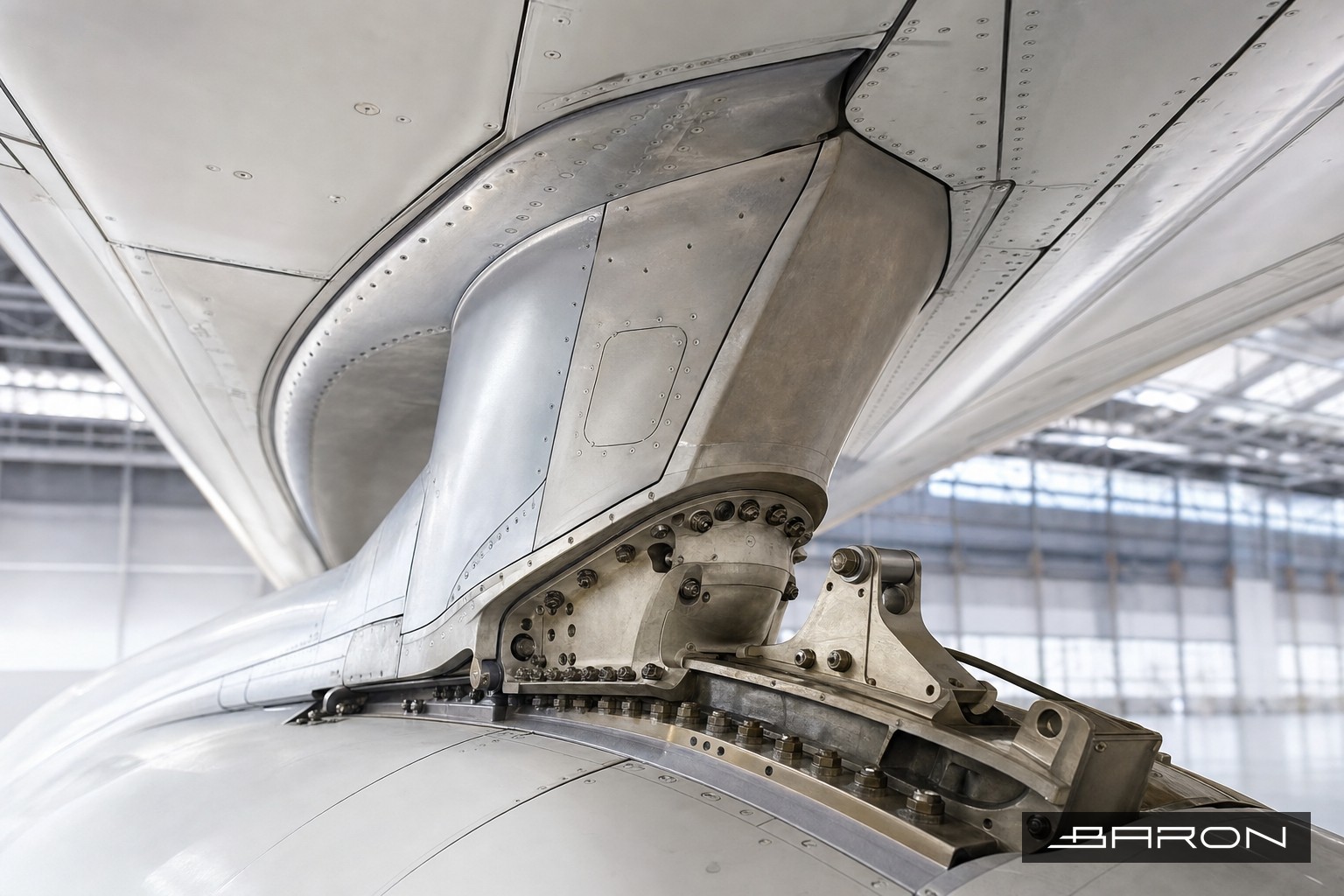 Commercial jet engine pylon attachment fittings under the wing in a maintenance hangar