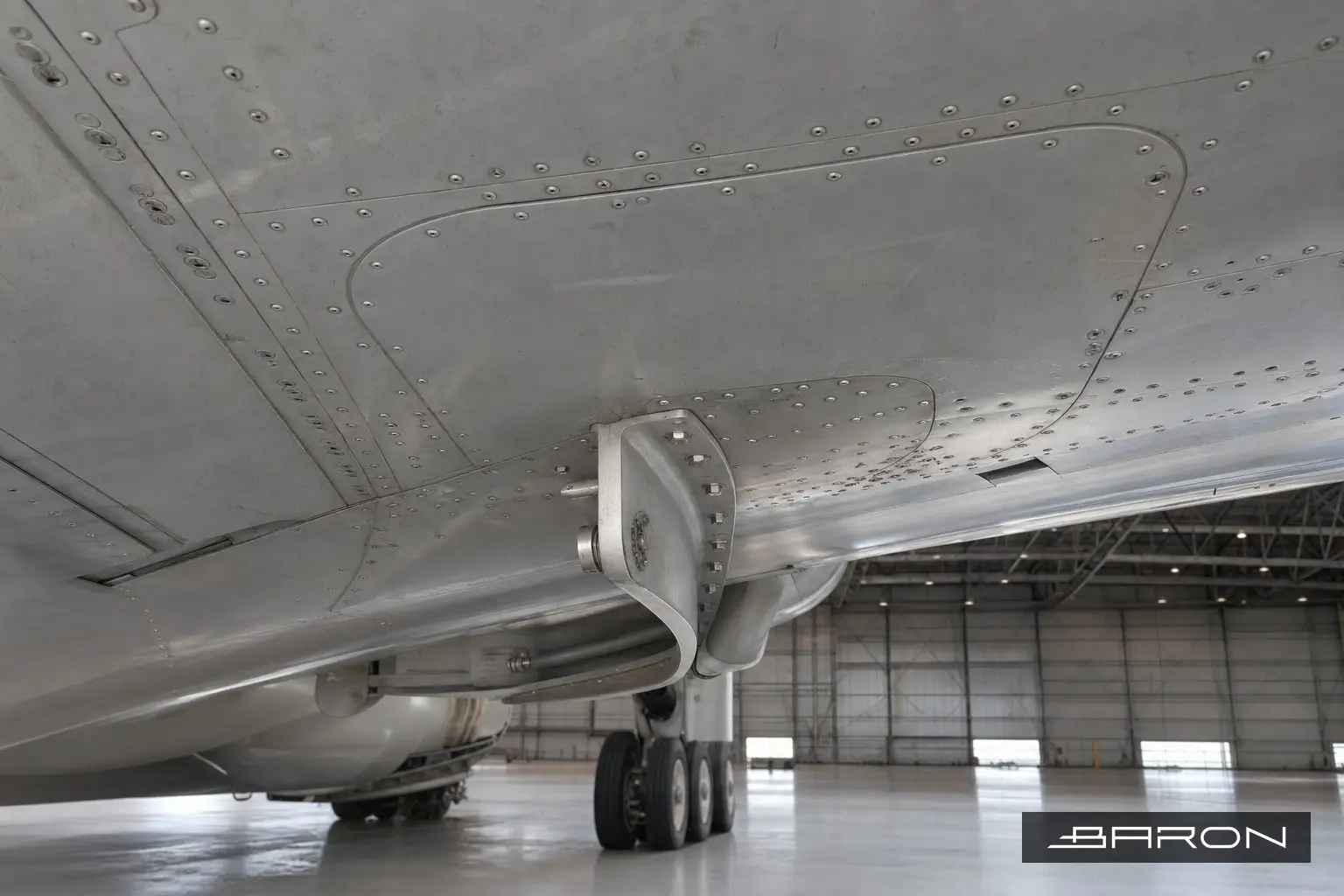 Aircraft wing lower skin underside with riveted doubler and brace fitting, radiographic inspection subject